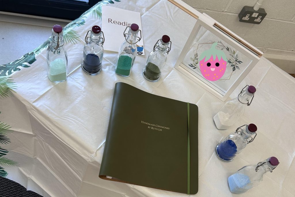 table with folder and glass jars, in preparation for a naming ceremony